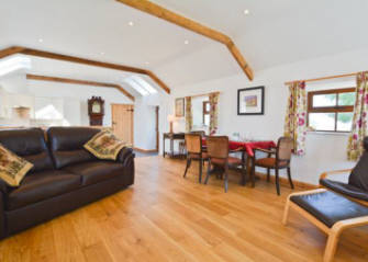 Comfortable lounge and dining area at  Curlew Cottage, self catering cottage, holiday accommodation , Lilswood Farm, Hexham, Northumberland England uk